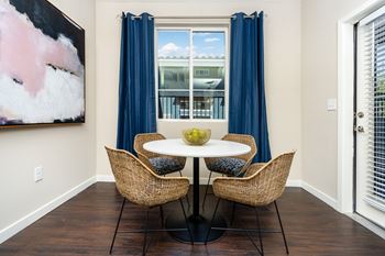 A dining room with a table and chairs.